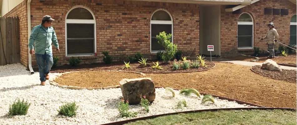 Landscapers installing rocks at home in Dallas, TX.
